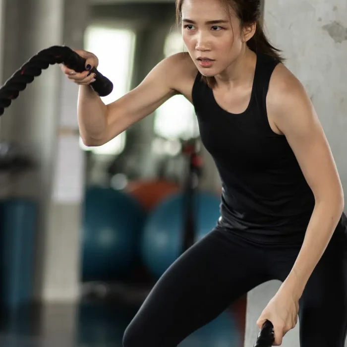 young-woman-exercising-with-rope-gym